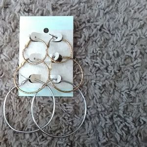 to pairs of Golden Hoops one pair of silver Hoops